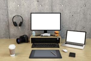 Digital Editing equipment a camera, computer, laptop headphones on a desk